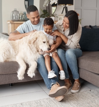 family petting their dog