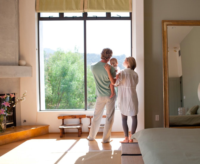 Family in front of a window in their home